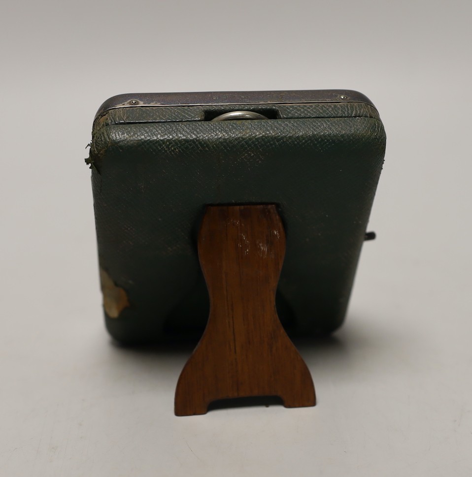 An Edwardian silver mounted travelling watch case, Birmingham, 1906, containing a nickel cased pocket watch, case diameter 66mm.